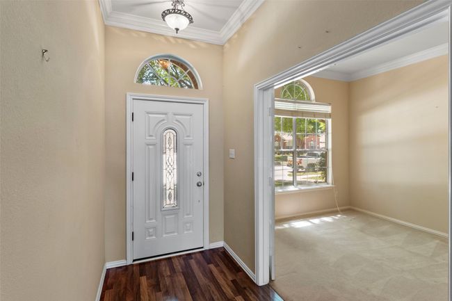 Entrance foyer featuring crown molding and baseboards | Image 6