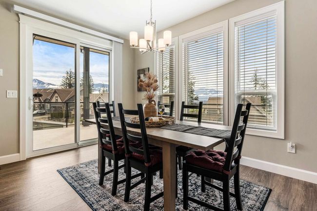 Dining area featuring baseboards, wood finished floors, and a chandelier | Image 18