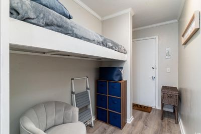 Bedroom featuring ornamental molding and hardwood / wood-style floors | Image 3