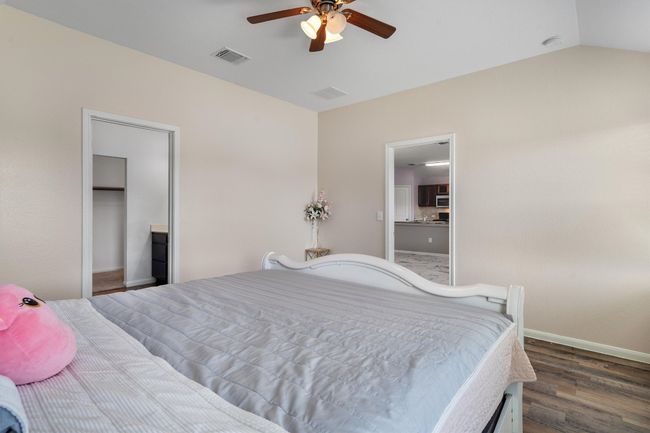 Bedroom with wood finished floors, baseboards, and ceiling fan | Image 13