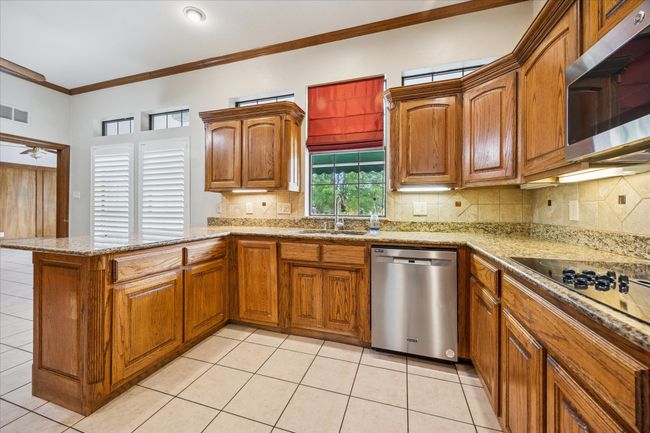 You can look out at your resort style back yard while cooking dinner. | Image 21