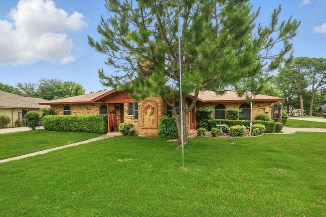 Ranch-style house featuring brick and a landscaped front yard | Image 32