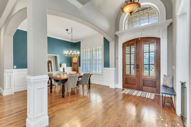 Guests are welcomed through your arched double doors into an inviting foyer with high barreled ceiling. This home has stunning, custom architectural detail. | Image 23