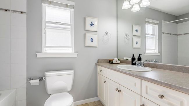 Full bathroom with a notable chandelier, vanity, a shower, and toilet | Image 19