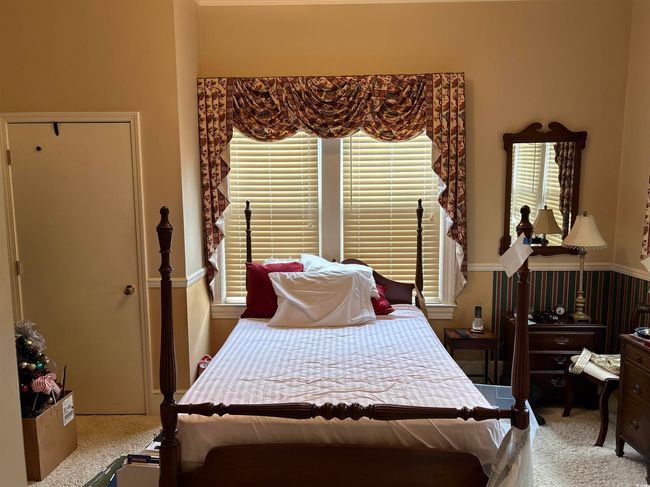 Bedroom featuring light carpet | Image 17