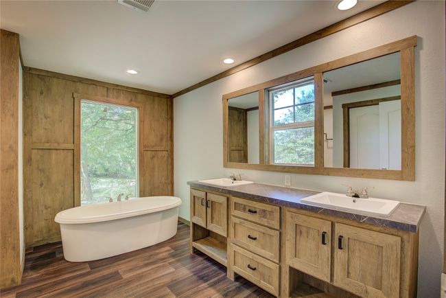 Bathroom with double vanity, a freestanding bath, wood finished floors, and recessed lighting | Image 12