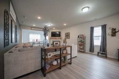 View from the kitchen of the living room with the wood burning fireplace and you can also see into the dining room/sunroom. | Image 3