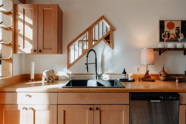 Kitchen featuring sink, stainless steel dishwasher, and light brown cabinets | Image 4