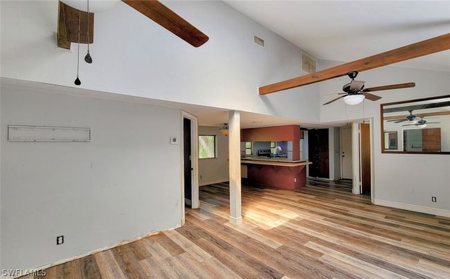 Living room with ceiling fan, beam ceiling, light hardwood / wood-style floors, and high vaulted ceiling | Image 5