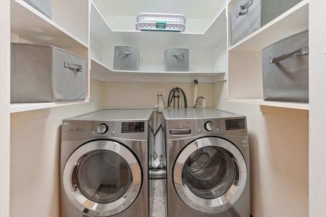 Laundry room featuring washing machine and clothes dryer and laundry area | Image 12