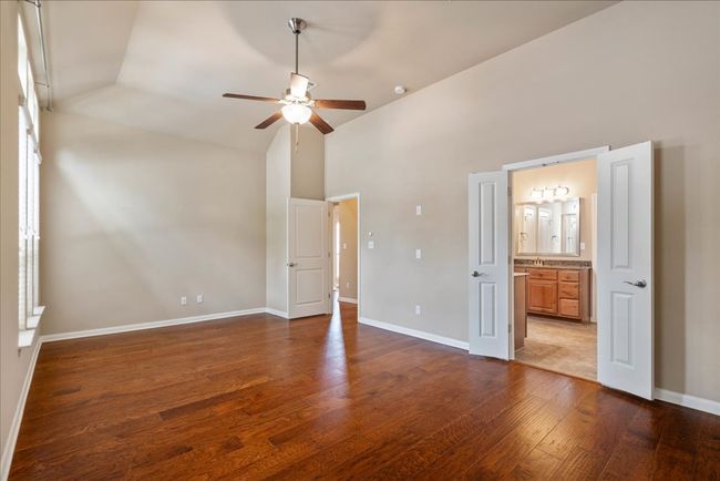 The primary bedroom is located off of the front of the house, split from the other bedrooms. | Image 8