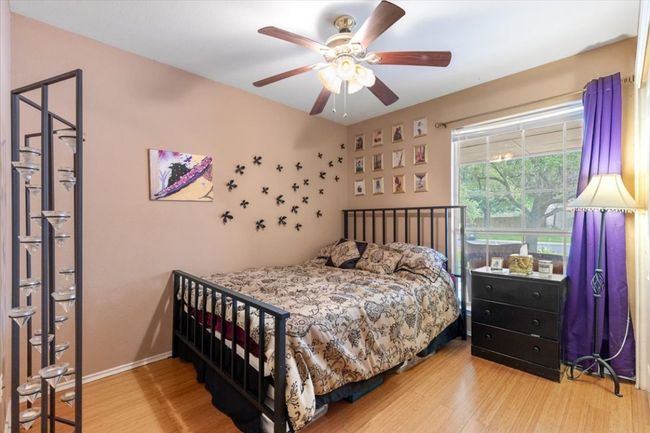Bedroom with wood finished floors, ceiling fan, and baseboards | Image 28