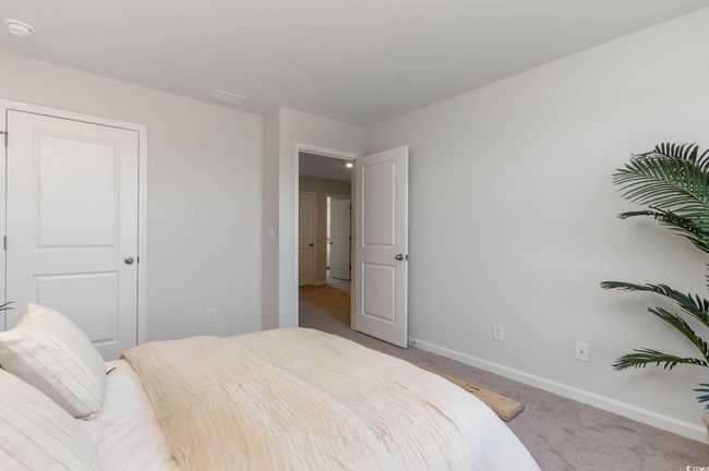 Bedroom featuring baseboards and light colored carpet | Image 20