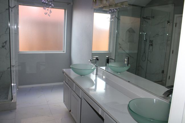 Bathroom featuring a sink, a marble finish shower, and marble finish floor | Image 22