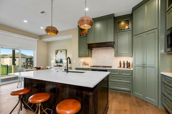 Kitchen with island and walk in pantry. Photos of previous model home. Not actual listing. Features and sizes may vary. Contact agent for details & showings! | Image 9