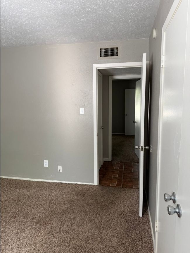 Empty room featuring carpet flooring and a textured ceiling | Image 18