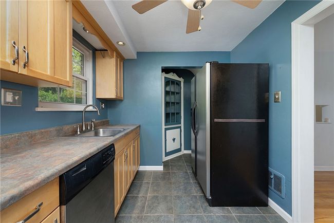 Kitchen: Built-in cupboard on the way to the basement. | Image 13