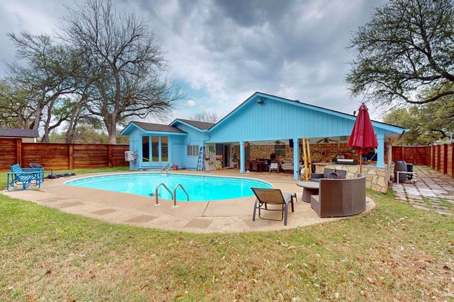 View of pool with an outdoor living space, a fenced in pool, a fenced backyard, a patio, and a lawn | Image 35