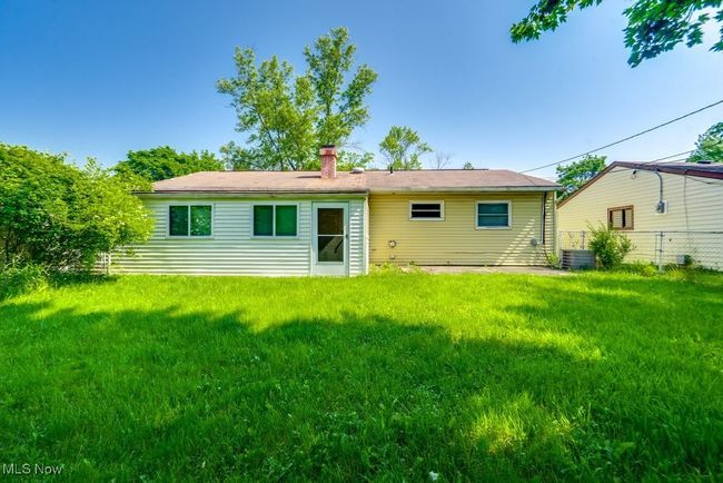 Rear view of property featuring a chimney and central AC | Image 6
