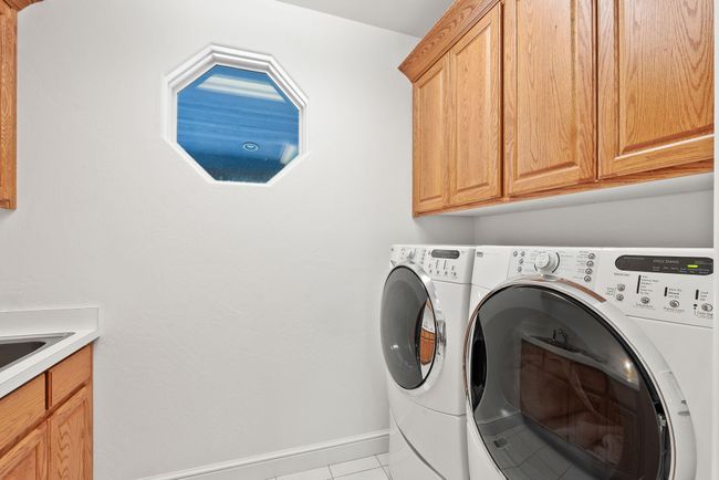 Main level laundry room w/ oak cabinets | Image 27