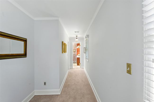 Hallway featuring light carpet and ornamental molding | Image 32
