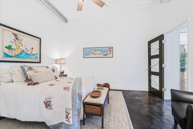 Bedroom with finished stained concrete floors and a ceiling fan | Image 19