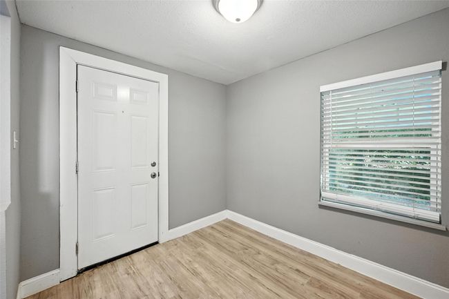 Foyer with light wood finished floors and a textured ceiling | Image 14
