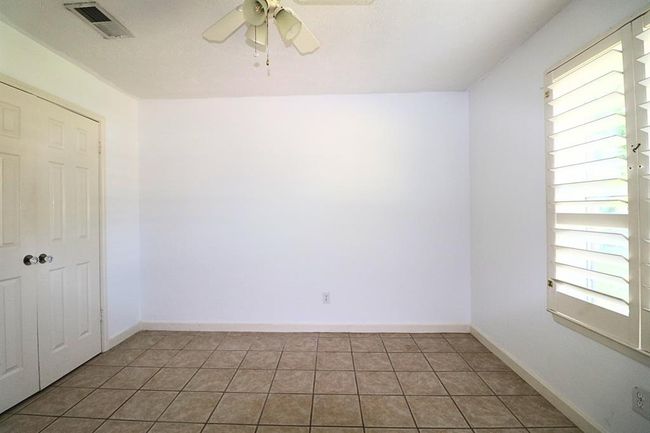Third bedroom with premium plantation shutters, new double window and ceiling fan | Image 17