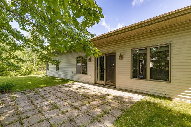 Patio door from Dining / Living area leads out to paver patio - ready for outdoor entertaining! | Image 40