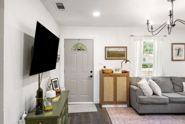Living area featuring dark wood-type flooring, a chandelier, and recessed lighting | Image 6