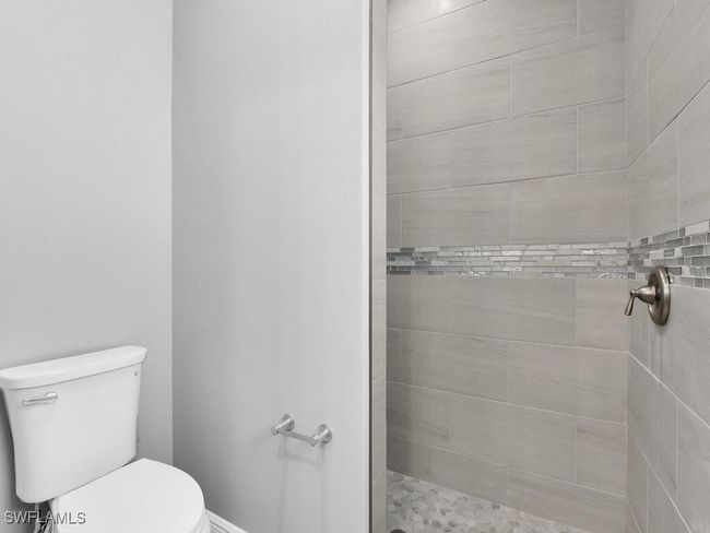 Full bath featuring a tile shower and toilet | Image 27