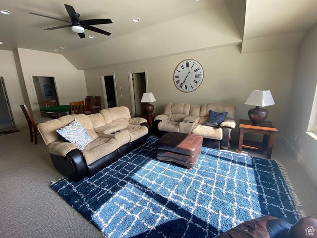 Carpeted living room featuring vaulted ceiling and ceiling fan | Image 21