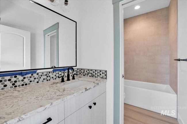 Bathroom with vanity, wood finished floors, tub / shower combination, and recessed lighting | Image 24