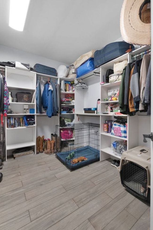 Spacious closet attached to laundry room with wood finished floors | Image 22