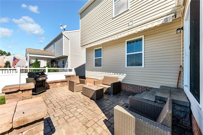 Paver stone patio with retractable awning. | Image 37