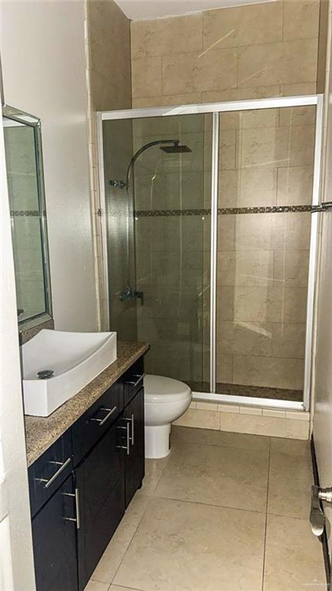 Shared bathroom complete with walk in shower. | Image 11
