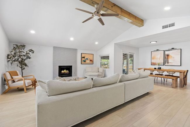 And that fireplace—seriously, it’s a vibe. It’s painted a soft, modern gray, and it just feels like the heart of the room. | Image 9