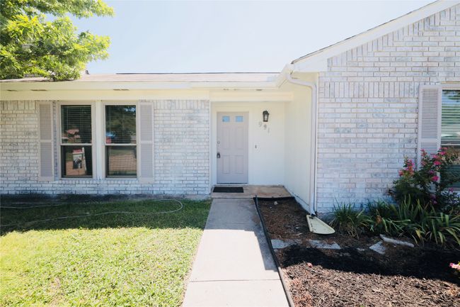 Doorway to property with brick siding and a yard | Image 5