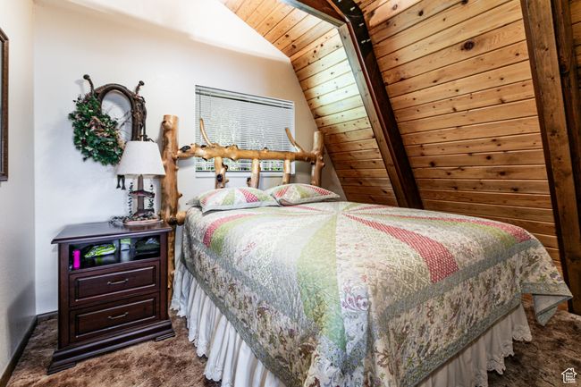 Carpeted bedroom featuring wooden ceiling and lofted ceiling | Image 16
