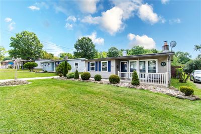 Ranch-style home featuring a front yard and a porch | Image 2