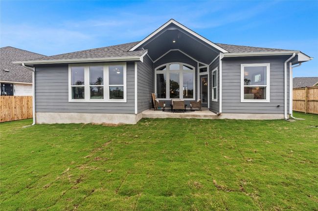 Rear view of house featuring a fenced backyard and a patio | Image 15