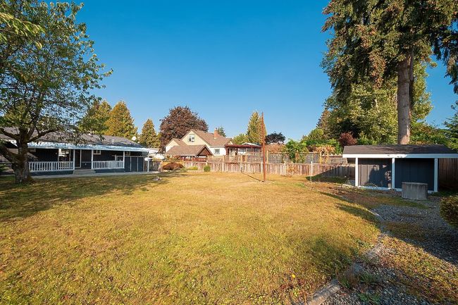 View of yard with a storage shed | Image 34