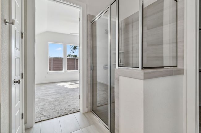 Full bath featuring a shower stall, tile patterned floors, and lofted ceiling | Image 23