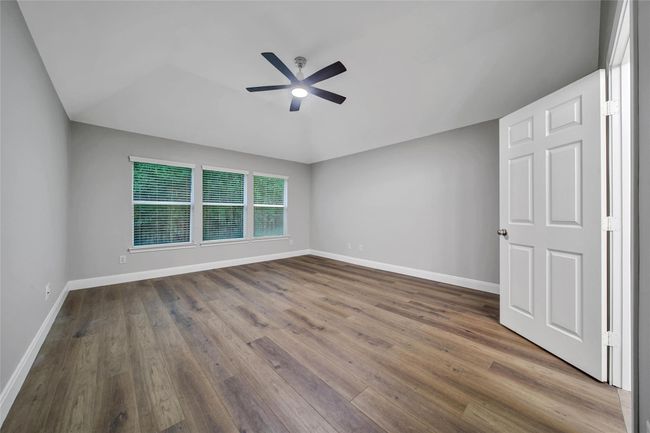 Relax and unwind in the private owner's suite nestled at the back of the home overlooking the wooded greenbelt. | Image 16