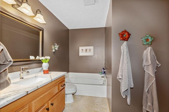 Upstairs main full bath with walk-through to the primary bedroom. There is a large linen closet plus another closet in the hallway. | Image 22