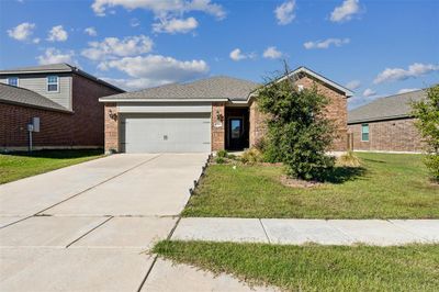 View of front of property featuring a garage and a front lawn | Image 1