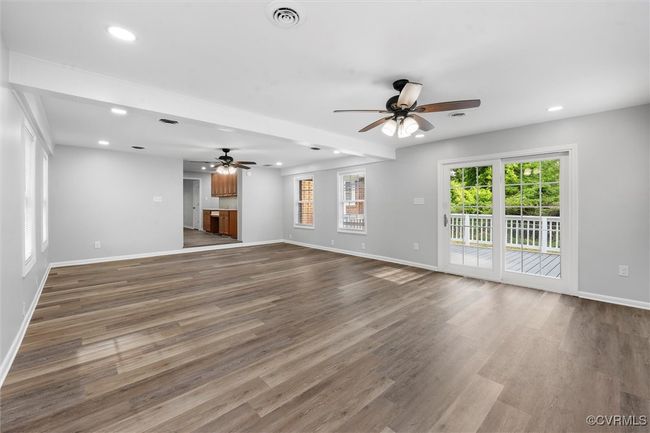 Unfurnished living room with recessed lighting, a ceiling fan, visible vents, and baseboards | Image 15