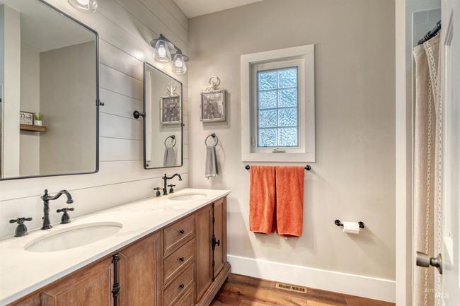 Bathroom featuring double vanity and wood finished floors | Image 20