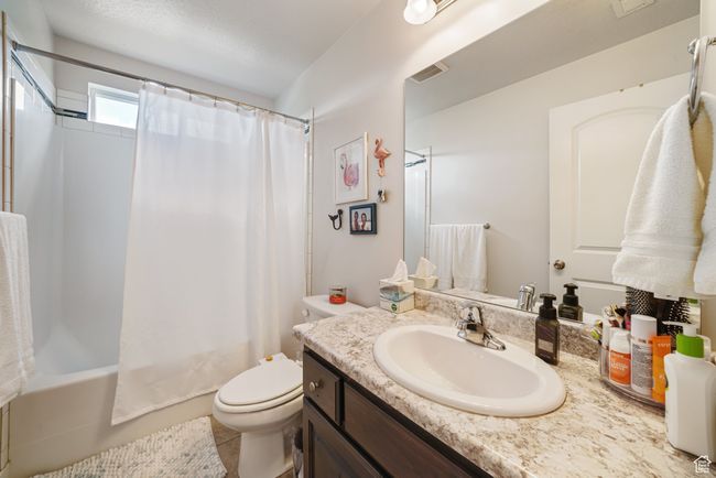 Bathroom featuring vanity and shower / bath combo with shower curtain | Image 20
