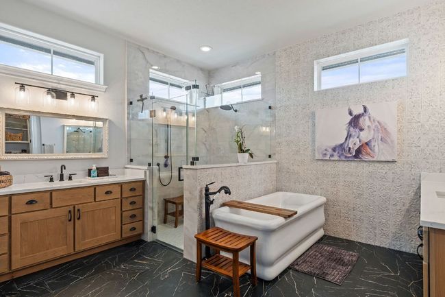 Bathroom with marble style finish floor, a healthy amount of sunlight, and a shower stall | Image 30